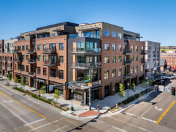 An aerial view of the Riverwalk Luxe Building exterior from the corner